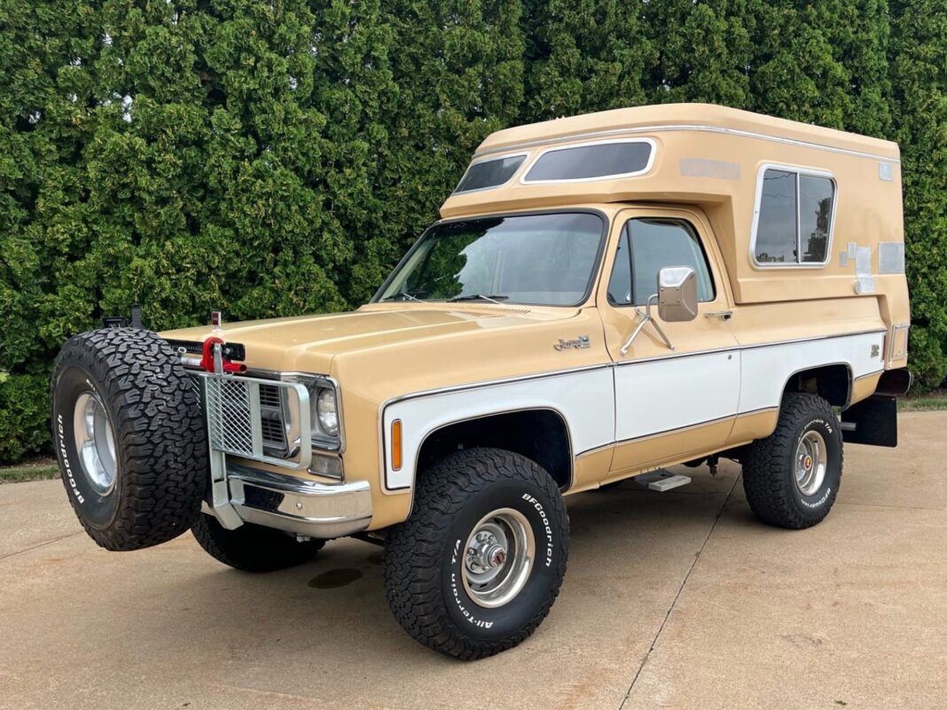 1977 GMC Jimmy Casa Grande vintage 4x4 camper in gold and white with pop-top roof parked outdoors